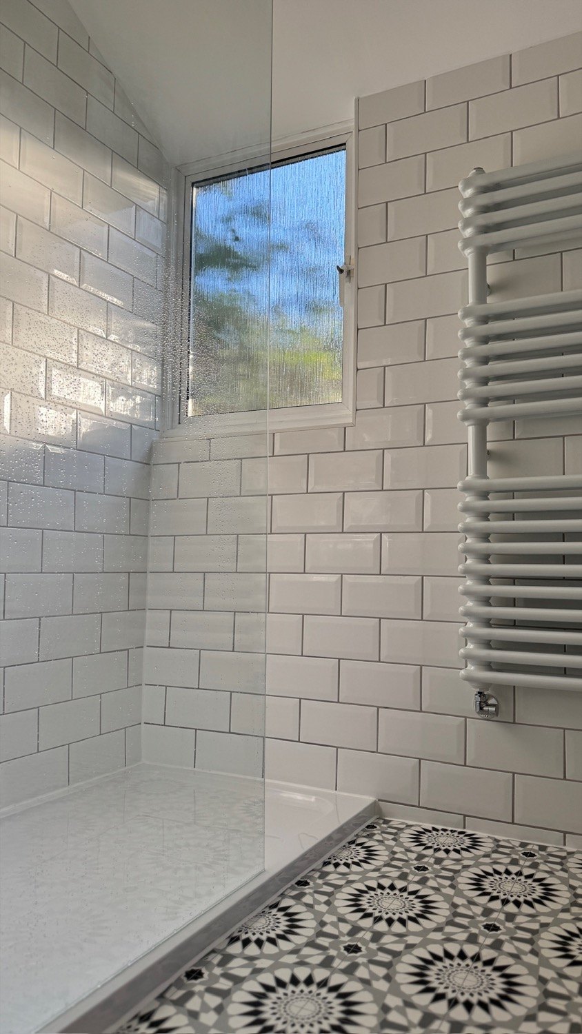 Walk-in shower enclosure with subway tiles and patterned floor, Rickmansworth